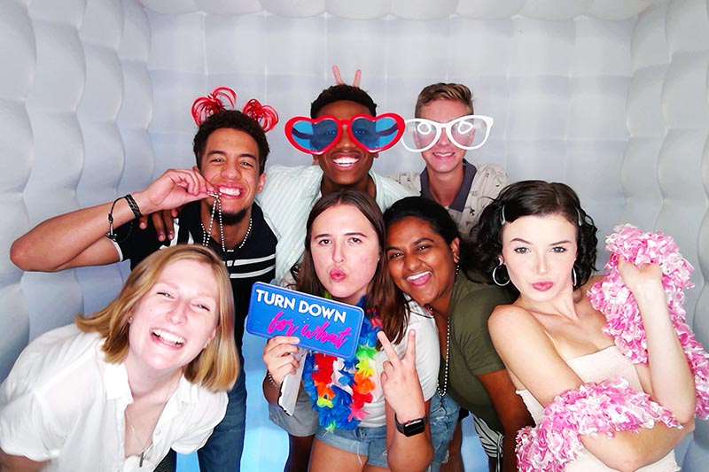 group posing in a party photo booth in Houston